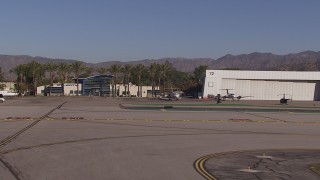 HD stock footage aerial video approach civilian jets by aviation building at Burbank Airport, California Aerial Stock Footage | CAP_021_135