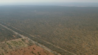 HD stock footage aerial video of flying toward open savanna, Zimbabwe Aerial Stock Footage | CAP_026_017