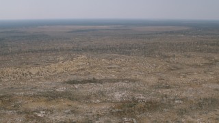 HD stock footage aerial video of flying over savanna and tilting to trees and brush, Zimbabwe Aerial Stock Footage | CAP_026_040