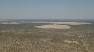 HD stock footage aerial video of flying by clearings in the trees and brush in the savanna, Zimbabwe Aerial Stock Footage | CAP_026_042