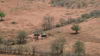 CAP_026_059 - HD stock footage aerial video of orbiting huts and fields in a small village, Zimbabwe