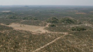 HD stock footage aerial video of flying toward hills beside fields with view of savanna, Zimbabwe Aerial Stock Footage | CAP_026_062