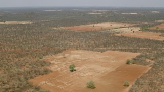 HD stock footage aerial video of flying by fields in the savanna, Zimbabwe Aerial Stock Footage | CAP_026_065