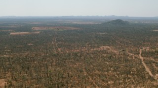 HD stock footage aerial video of flying by fields and hills in the savanna, Zimbabwe Aerial Stock Footage | CAP_026_066