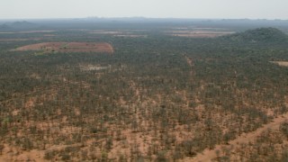 HD stock footage aerial video of passing by fields and hills in the savanna, Zimbabwe Aerial Stock Footage | CAP_026_067