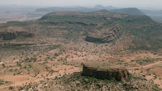 HD stock footage aerial video of orbiting a village beside green mountains in Zimbabwe Aerial Stock Footage | CAP_026_100