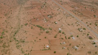 HD stock footage aerial video of orbiting homes in a village near the road in Zimbabwe Aerial Stock Footage | CAP_026_104