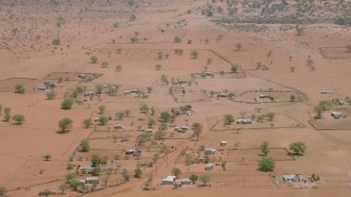 HD stock footage aerial video of orbiting houses in an African village in Zimbabwe Aerial Stock Footage | CAP_026_111