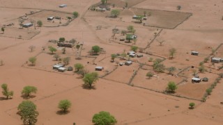 CAP_026_112 - HD stock footage aerial video of circling houses in an African village in Zimbabwe