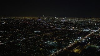 DCA01_007 - 5K aerial stock footage tilt up revealing downtown Los Angeles skyline at night, California