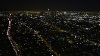 5K aerial stock footage tilt up revealing downtown Los Angeles skyline at night, California Aerial Stock Footage | DCA01_009