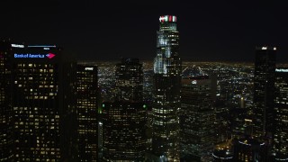 DCA01_013E - 5K aerial stock footage tilt from freeway to reveal Downtown Los Angeles skyscrapers and city lights, California