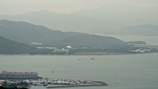 DCA02_006 - 4K aerial stock footage of Hong Kong Disneyland across Discovery Bay on Lantau Island, Hong Kong, China