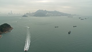 4K aerial stock footage approach ferries and cargo ships near Hong Kong Island and Victoria Harbor, China Aerial Stock Footage | DCA02_009