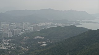 4K aerial stock footage pan from Tolo Harbor to reveal Tai Po apartment buildings in the New Territories, Hong Kong, China Aerial Stock Footage | DCA02_025