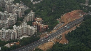 4K aerial stock footage of light traffic on Tolo Highway by apartment buildings in the New Territories, Hong Kong, China Aerial Stock Footage | DCA02_027