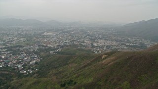 4K aerial stock footage pan across Shek Kong neighborhoods and green mountain ridge in the New Territories, Hong Kong, China Aerial Stock Footage | DCA02_030