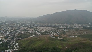 4K aerial stock footage of Shek Kong neighborhoods and Kai Kung Leng mountain peak in the New Territories, Hong Kong, China Aerial Stock Footage | DCA02_031