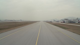 DCA02_034 - 4K aerial stock footage of lifting off from a runway at Hong Kong International Airport, China