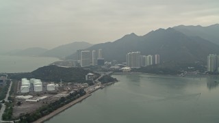 4K aerial stock footage of jet fuel tanks near apartment complexes in Tung Chung, Lantau Island, Hong Kong, China Aerial Stock Footage | DCA02_036