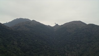 4K aerial stock footage approach the Ngong Ping Cable Car gondolas in the mountains of Lantau Island, Hong Kong, China Aerial Stock Footage | DCA02_037