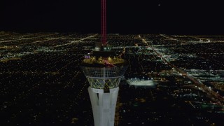 4K aerial stock footage of orbiting top of Stratosphere with city sprawl in background, Las Vegas, Nevada Night Aerial Stock Footage | DCA03_007