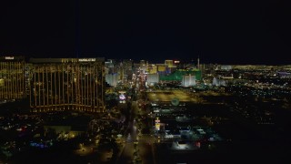 4K aerial stock footage of Las Vegas Boulevard to Mandalay Bay, hotels and casinos in background, Las Vegas, Nevada Night Aerial Stock Footage | DCA03_013