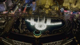 4K aerial stock footage of flying over The Bellagio with Paris in background, tilting to the water show, Las Vegas, Nevada Night Aerial Stock Footage | DCA03_023