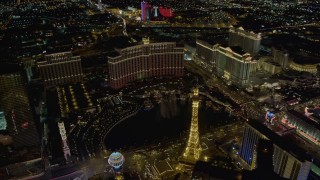 4K aerial stock footage of The Bellagio Fountain between The Bellagio and Paris, Las Vegas, Nevada Night Aerial Stock Footage | DCA03_027