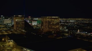 4K aerial stock footage of The Hotel and Mandalay Bay Resort, revealing Luxor Hotel, Las Vegas, Nevada Night Aerial Stock Footage | DCA03_052