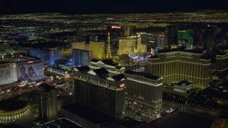 4K aerial stock footage tilt from Caesar's Palace and flyby hotels on Las Vegas Strip, Nevada Night Aerial Stock Footage | DCA03_188