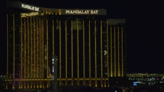 4K aerial stock footage of flying by Luxor Hotel and Casino, revealing Mandalay Bay, Las Vegas, Nevada Night Aerial Stock Footage | DCA03_219