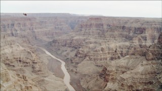 DCA04_026 - 4K aerial stock footage of a helicopter flying over the Colorado River in Grand Canyon, Arizona