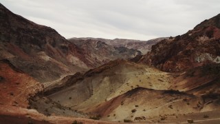 DCA04_071 - 4K aerial stock footage of flying over dunes to reveal a dry riverbed in the  Hiller Mountains, Nevada