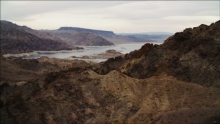 4K aerial stock footage of flying over rocky ridges toward Lake Mead, Hiller Mountains, Nevada Aerial Stock Footage | DCA04_081