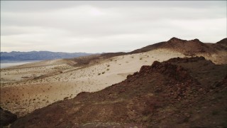 DCA04_088 - 4K aerial stock footage of flying over sandy dunes near Lake Mead, Nevada