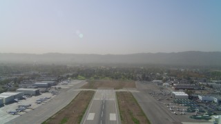 DCA05_003 - 4K aerial stock footage of ascending over runway Van Nuys Airport; Van Nuys, California