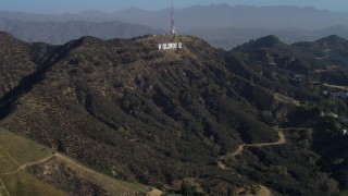 DCA05_005 - 4K aerial stock footage of flying over Hollywood Hills, approaching Hollywood Sign, Los Angeles, California