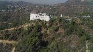 4K aerial stock footage tilt up hill, revealing Griffith Observatory, Los Angeles, California Aerial Stock Footage | DCA05_016