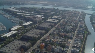 DCA05_066 - 4K aerial stock footage of flying by boats in the marina, residential neighborhoods, Marina Del Rey, California