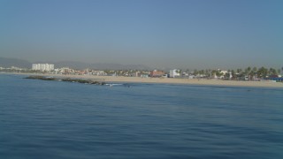 4K aerial stock footage of flying low over ocean with a view of the beach, Venice, California Aerial Stock Footage | DCA05_076