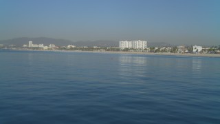 4K aerial stock footage of fly low over Pacific Ocean near beach, tracking a rower, Santa Monica, California Aerial Stock Footage | DCA05_077