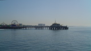 DCA05_091 - 4K aerial stock footage of flying low over the ocean, approaching Santa Monica Pier, Santa Monica, California