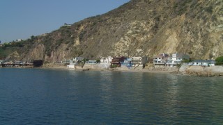 4K aerial stock footage of flying over the ocean, approaching coastal Malibu homes, Malibu, California Aerial Stock Footage | DCA05_104