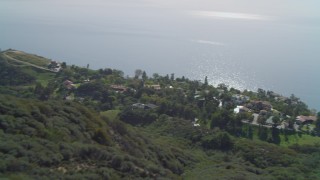 4K aerial stock footage of hiking trail on hill, homes on cliff overlooking the Pacific Ocean, Malibu, California Aerial Stock Footage | DCA05_110