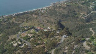 4K aerial stock footage pan across hills, revealing residential neighborhoods, coastline, Malibu, California Aerial Stock Footage | DCA05_111