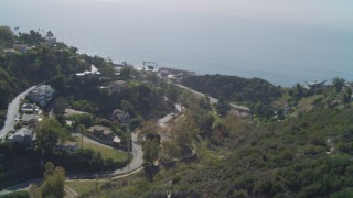 4K aerial stock footage tilt from canyon to reveal coastal neighborhood, coast, ocean, Malibu, California Aerial Stock Footage | DCA05_114