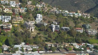 4K aerial stock footage of flying by hillside homes, focusing on custom home, Malibu, California Aerial Stock Footage | DCA05_115