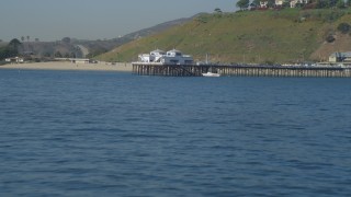 4K aerial stock footage of flying over small waves in ocean, revealing Malibu Pier, Malibu, California Aerial Stock Footage | DCA05_119