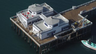 4K aerial stock footage of flying over Malibu Pier, and tilt to a bird's eye view, Malibu, California Aerial Stock Footage | DCA05_120